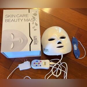 NEWKEY LED Face Mask Light Therapy. Has 7 different colored LED lights.